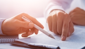 Men signing contracts